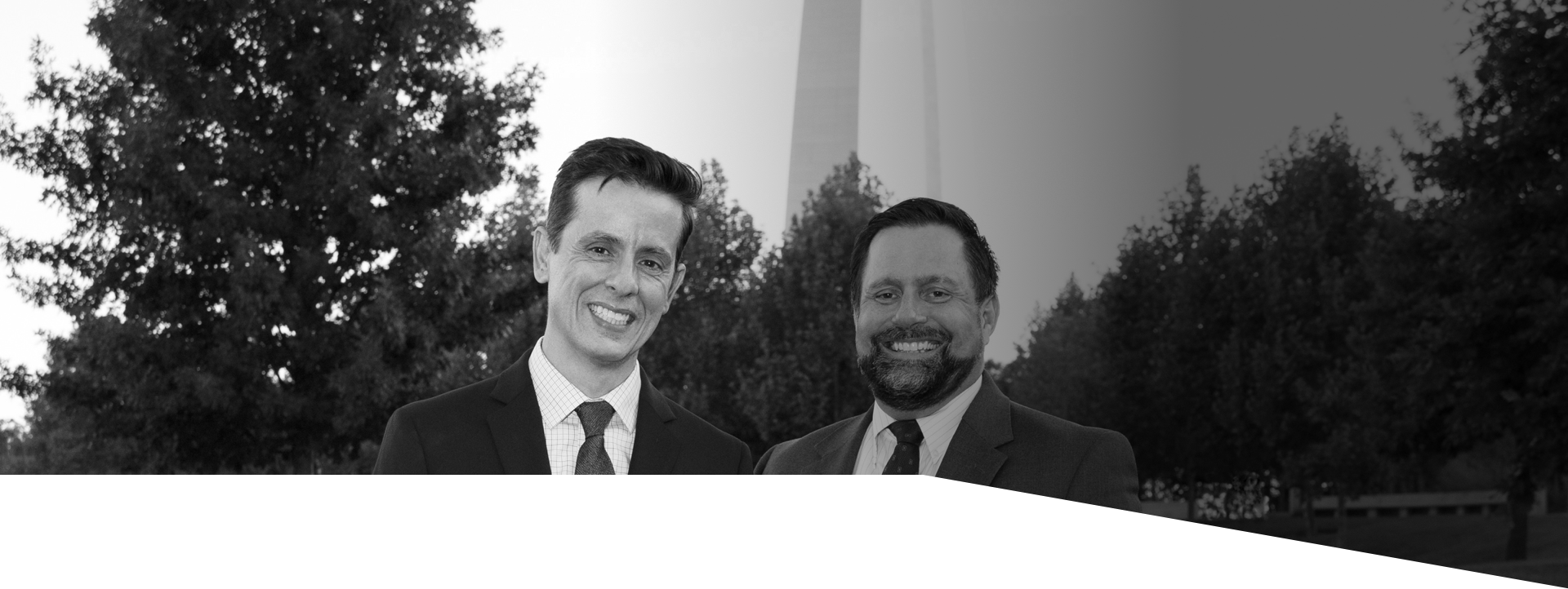 Gustavo Arango and Kenneth K. Schmitt standing outside with the Arch in the background and smiling